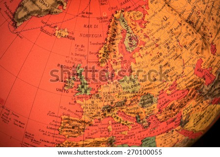 MILAN, ITALY - DECEMBER 17, 2014: red world globe with closeup on Europe and black background in Milan, Italy.  A globe is the only representation of the earth that does not distort its shape or size