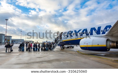 TRAPANI, ITALY - FEBRUARY 25, 2014: passengers boarding Ryanair Jet airplane in Trapani airport, Italy. Ryanair is the biggest low-cost airline company in the world.