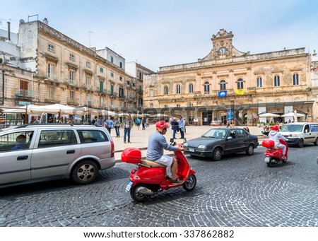 OSTUNI, ITALY - MAY 16, 2015: tourists visit old town and Statue of San Oronzo in Ostuni, Italy. Ostuni is one of the most beautiful and famous towns in Apulia.