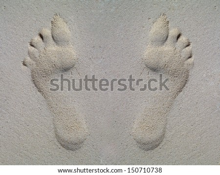 Footsteps in sand on the beach