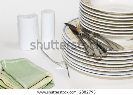 Getting ready for dinner; Plates, cutlery, pepper, salt and napkin