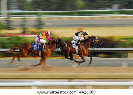Jockeys on a horses racing on race track