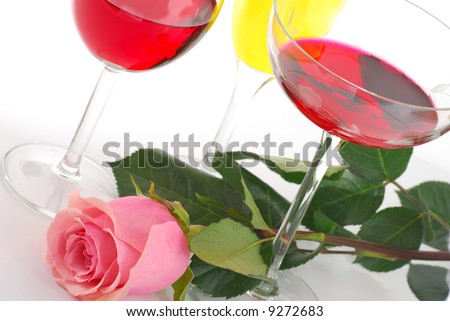 Pink rose and wine on white background