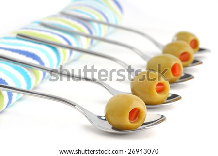 Stuffed green olives in a spoon studio isolated on white background