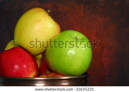 Bowl full of apples with an abstract red background