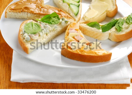 Several pieces of toast with various toppings on each