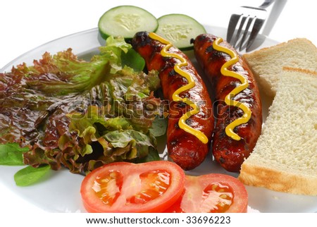Extreme close-up image sausages served with bread, tomatoes and lettuce
