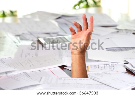 A large amount of bills spread all over the place with hand asking for help