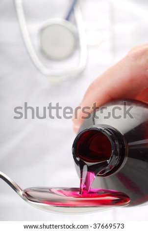 A bottle pouring cough syrup into a spoon with doctor in background