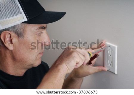 Close-up image of handy man fixing an electricity outlet