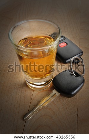 Do not drink and drive - glass of liquor and car keys on white