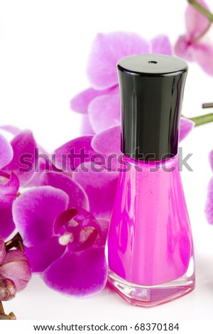 Image of nail polish with orchid in background