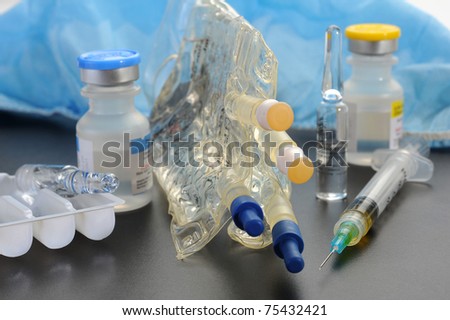 Extreme close-up image of  I. V. bag, syringe and vial