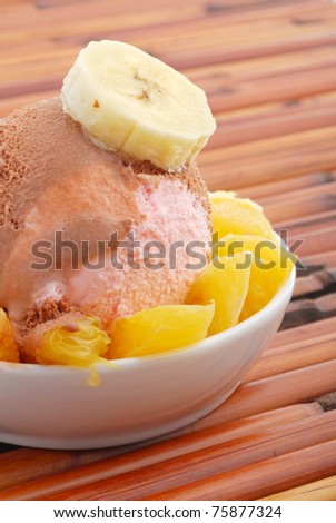 Ice Cream in bowl with oranges and banana