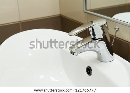 clean hotel bathroom sink and faucet