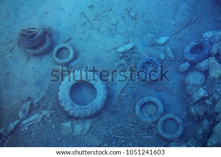 Sea pollution, old tires and other garbage underwater