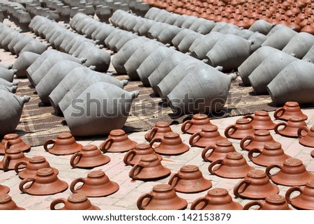Clay pots and plates drying on the street of Bhaktapur, Kathmandu Valley, Nepal