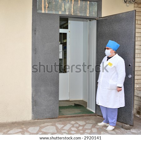 female doctor is standing near hospital entrance
