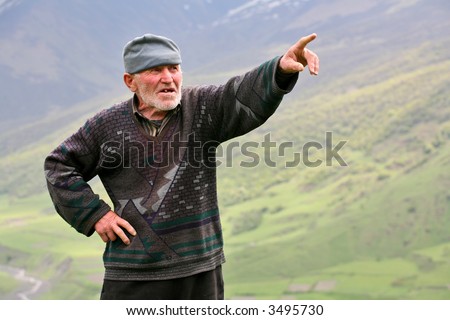 Old grey-haired man with mountains background