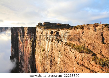 Sheer cliffs of Mount Roraima - landscape  with clouds background
