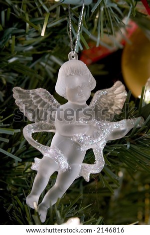 Crystal angel christmas decorations on silver light.