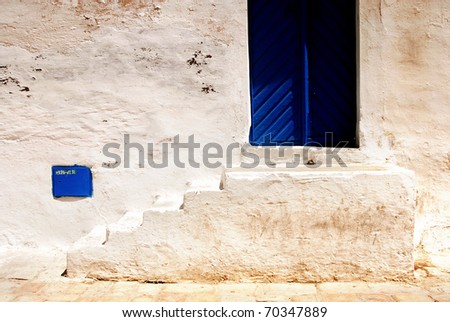 blue door whit white wall and stairs