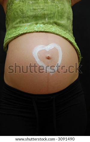 Pregnant woman with heart painted on her belly