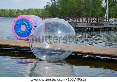 stock-photo-zorbing-air-bubbles-on-water-marina-resort-lake-in-trakai-most-visited-tourist-place-in-lithuania-103749515.jpg