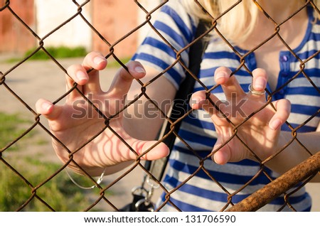 Woman claw hands rusty fence. Human movement freedom restrictions.