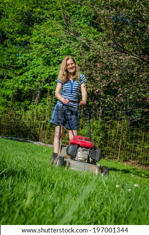 smiling country work woman and fuel grass cutting machine in garden seasonal work