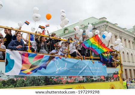 VILNIUS, LITHUANIA - JULY 27: open bus rides large group of participants in the Baltic pride gay parade with banners balloons flags on July 27, 2013 in Vilnius.