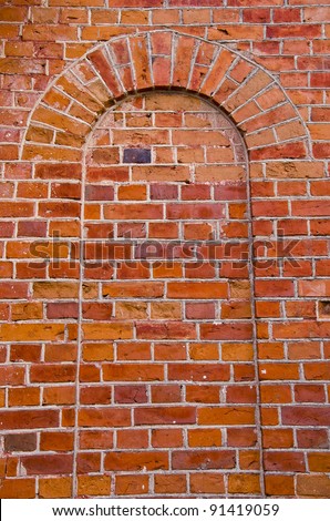 Arch with rounded top moored up with red brick. Architectural wall solutions.
