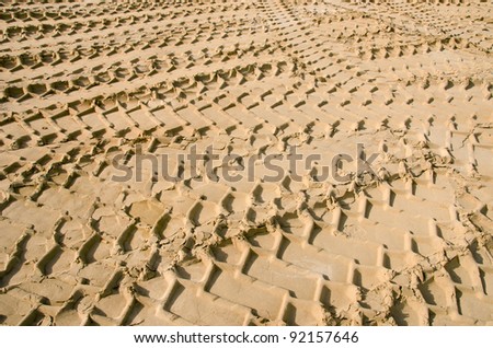 Freight car wheel marks in the sand. Transportation concept background.