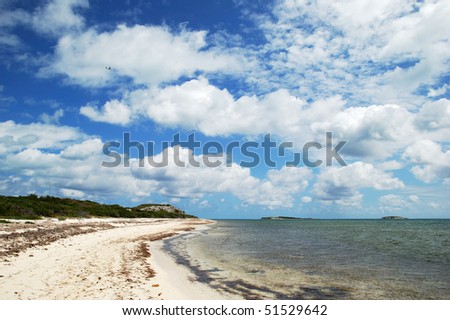 Cloudy blue sky over endless Grand Turk island beach (Turks & Caicos).