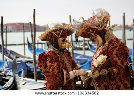 VENICE, ITALY -  MARCH 5: Unidentified couple in carnaval masks at St. Marco Square, Carnival of Venice on March 5, 2011. The annual carnival was held in 2011 from February 26 to March 8, 2011.