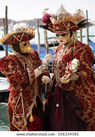 VENICE, ITALY -   MARCH 5: Unidentified couple in carnaval masks at St. Marco Square, Carnival of Venice on March 5, 2011. The annual carnival was held in 2011 from February 26 to March 8, 2011.