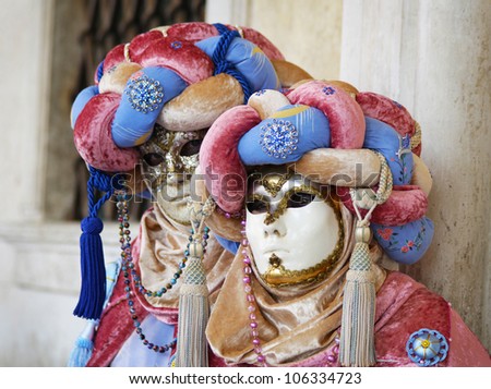 VENICE, ITALY MARCH 5: Unidentified couple in courtesan masks at St. Marco Square, Carnival of Venice on March 5, 2011. The annual carnival was held in 2011 from February 26 to March 8, 2011.