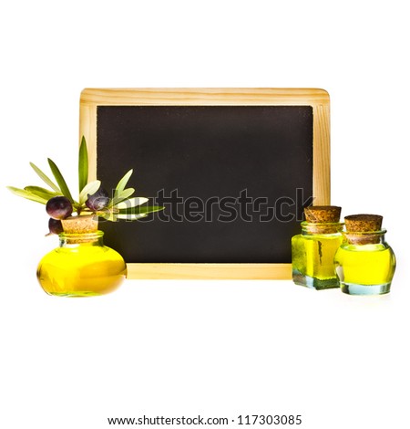 olive oil in small glass bottles, branches of olive and fruit, black writing board. isolated on white background