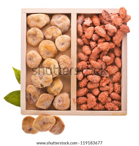 A set of dried fruit - figs and candied almonds. in a wooden box. isolated on white background