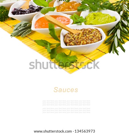 cooking sauces in white bowls and herbs isolated on a white background   with sample text