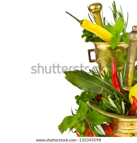 vegetables and fresh herbs. two copper mortar, a small bottle of olive oil isolated on white background