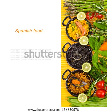 Spanish Mediterranean sea food - black rice, paella, noodles in a typical small pans on the yellow mat isolated on white background