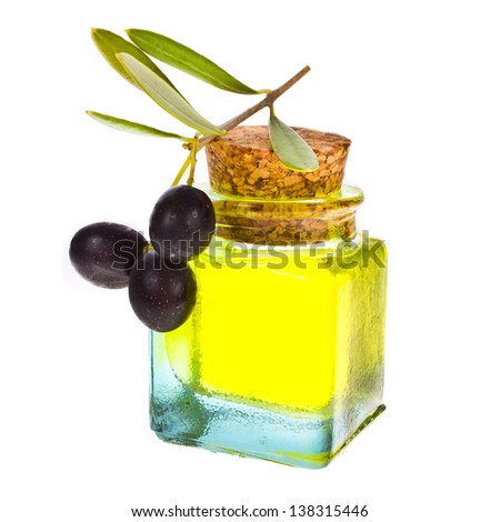 small glass bottle with olive oil, decorated with a small twig with black olives, fruit, isolated on white background