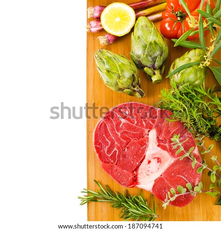 meat, a large piece of fresh meat, beef, to be on the  board, decorated with greens and vegetables   isolated on white background