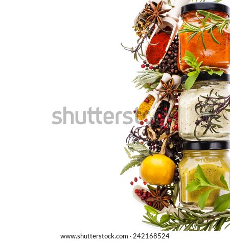 dry spices, fresh herbs and cooking sauces in jars board  isolated on white background