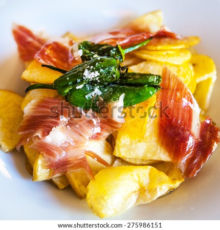 spanish tapas fried potatoes. ham and green peppers PadrÃ?Â³n