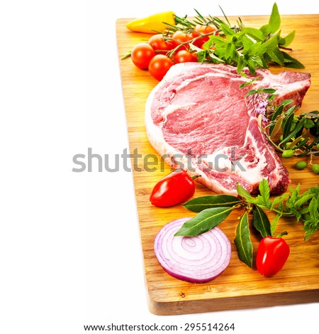 meat, a large pieces of fresh meat, beef, to be on the board, decorated with greens and vegetables isolated on white background