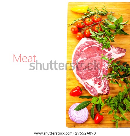 meat , a large pieces of fresh meat, beef, to be on the board, decorated with greens and vegetables isolated on white background