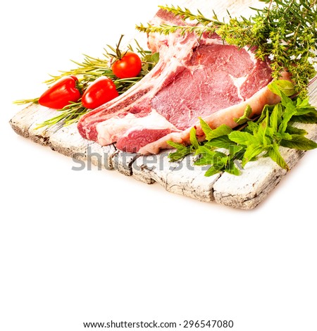 meat , a large pieces of fresh meat, beef, to be on the board, decorated with greens and vegetables isolated on white background