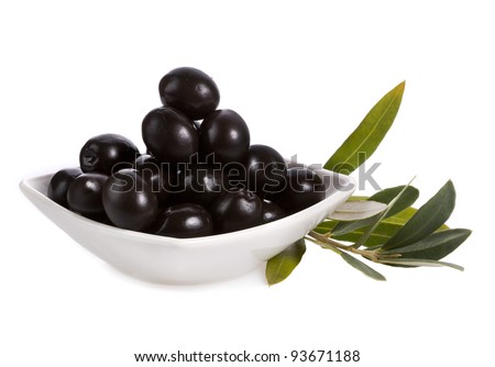 Pickle black olives in a bowl and olive tree branch on a white background Pickle black olives in a bowl and olive tree branch on a white background